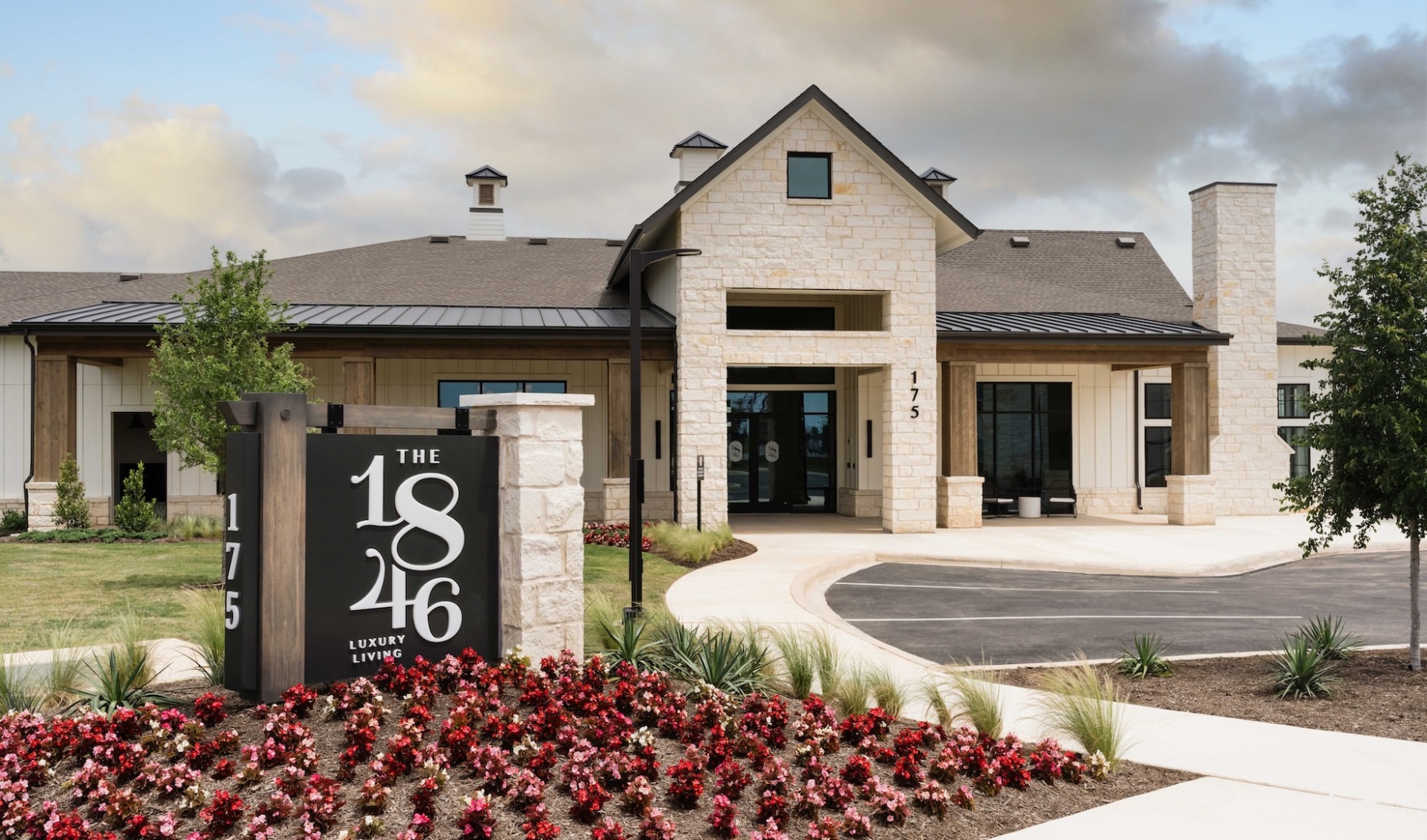 Elegant interior lounge area at 1846 Apartments, Fredericksburg, TX, with modern seating, warm lighting, large windows, and stylish decor in a spacious setting.