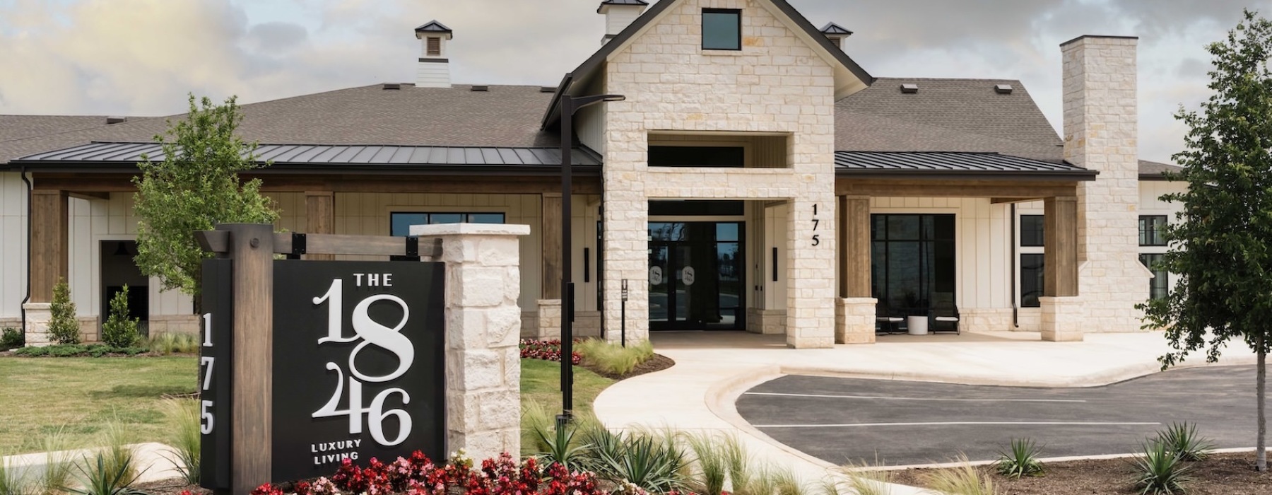 Elegant interior lounge area at 1846 Apartments, Fredericksburg, TX, with modern seating, warm lighting, large windows, and stylish decor in a spacious setting.